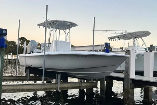 The Image of 2025 Contender 26 Bay boat docked on a lift at a marina. - 1