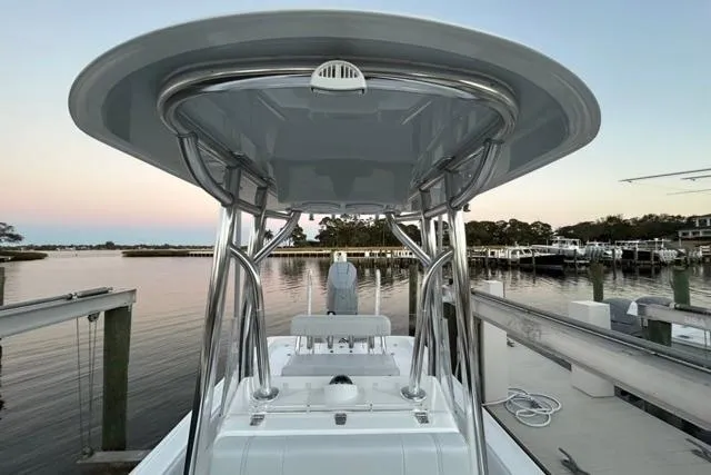 Slide: The Image of 2025 Contender 26 Bay boat docked at sunset, showcasing sleek design and modern features. - 19