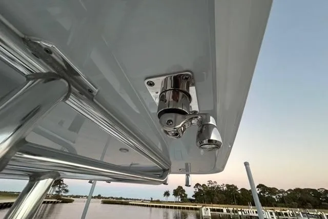 Slide: The Image of 2025 Contender 26 Bay boat with mounted stainless steel hardware, dockside view. - 22