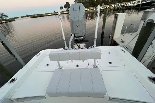 Slide: The Image of 2025 Contender 26 Bay boat at dock, featuring sleek design and modern outboard motor. - 23