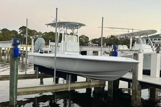 Slide: The Image of 2025 Contender 26 Bay boat docked at marina, side view. - 25