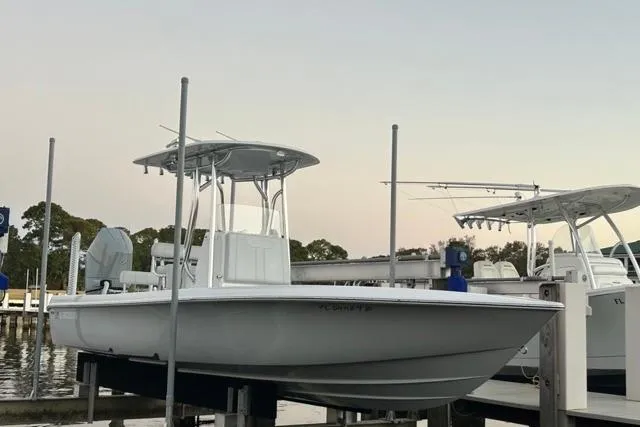 Slide: The Image of 2025 Contender 26 Bay boat docked at marina, featuring sleek design and modern amenities. - 26