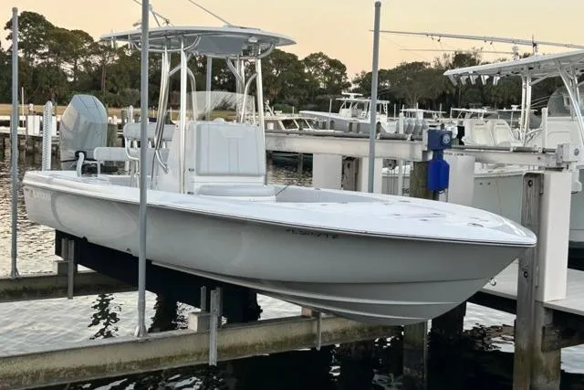 Slide: The Image of 2025 Contender 26 Bay boat docked, featuring sleek design and modern amenities. - 3