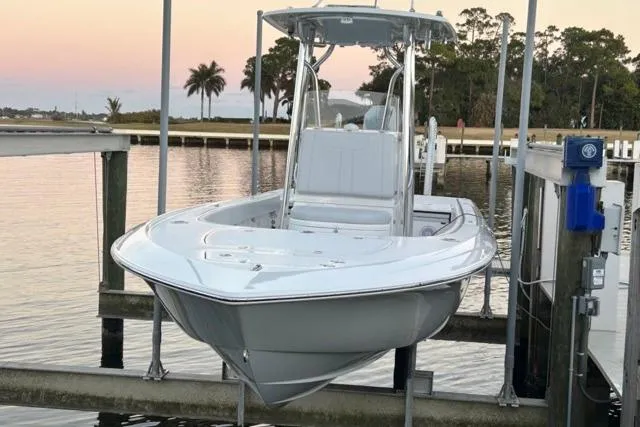 Slide: The Image of 2025 Contender 26 Bay boat docked at sunset, featuring sleek design and modern amenities. - 4