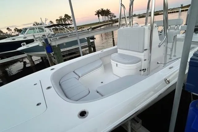 Slide: The Image of 2025 Contender 26 Bay boat with sleek white interior, docked at marina during sunset. - 6