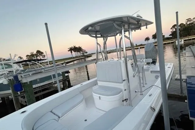 Slide: The Image of 2025 Contender 26 Bay boat docked at sunset, featuring sleek design and spacious seating. - 7