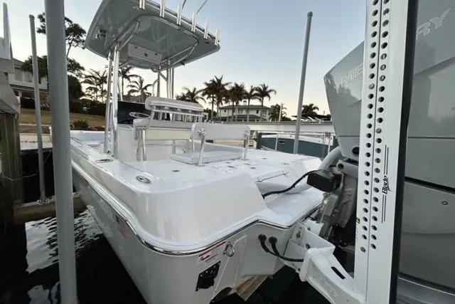 Slide: The Image of 2025 Contender 26 Bay boat docked, featuring sleek design and modern amenities. - 9