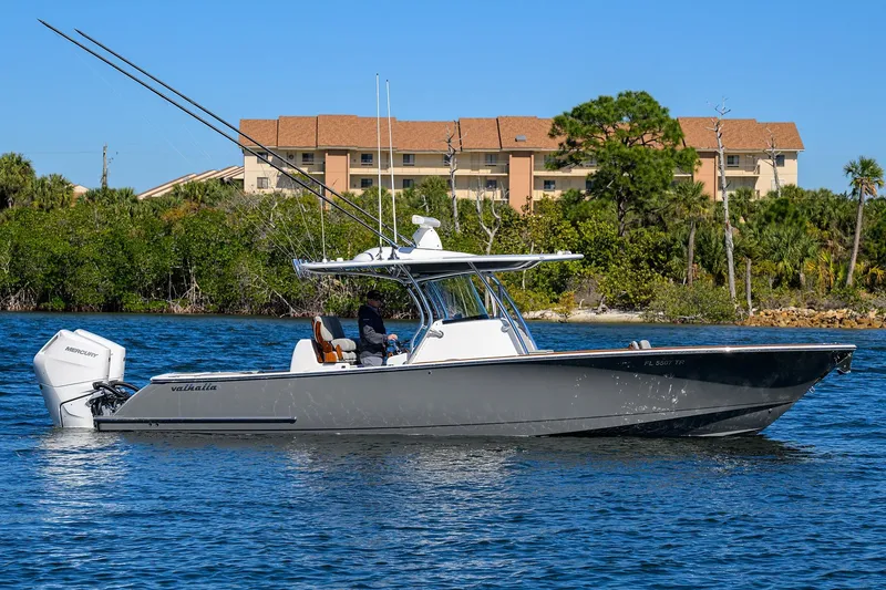 The Image of 2024 Valhalla Boatworks V-33 cruising on water with scenic background. - 0
