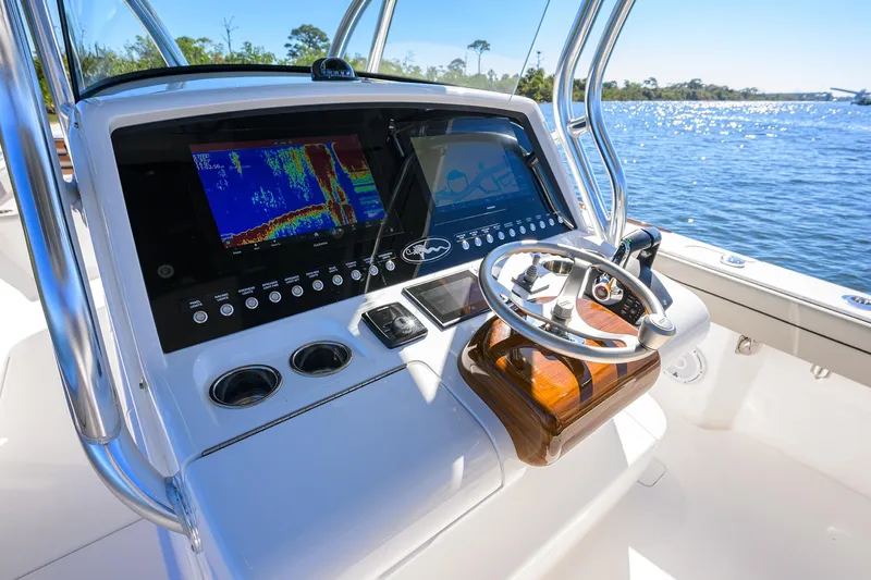 Slide: The Image of 2024 Valhalla Boatworks V-33 helm with advanced navigation system on a sunny day. - 10