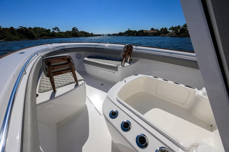 Slide: The Image of 2024 Valhalla Boatworks V-33 interior with seating and storage, cruising on a sunny day. - 14