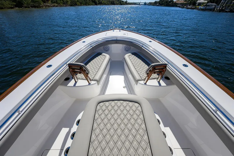 Slide: The Image of 2024 Valhalla Boatworks V-33 luxury seating on calm water. - 16