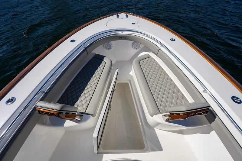 Slide: The Image of 2024 Valhalla Boatworks V-33 bow seating area with diamond-stitched cushions on open water. - 17