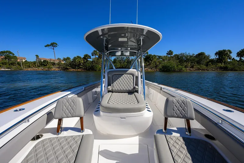 Slide: The Image of 2024 Valhalla Boatworks V-33 with luxurious seating on a serene waterway. - 20