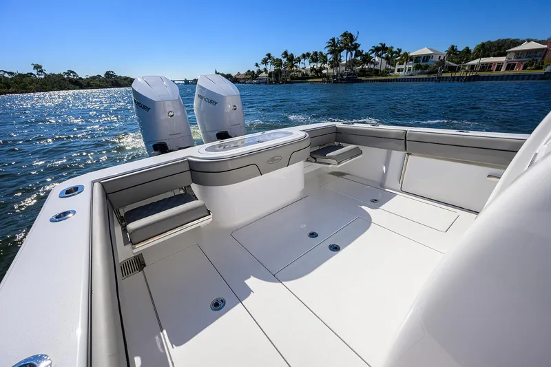 Slide: The Image of 2024 Valhalla Boatworks V-33, spacious deck, twin Mercury engines, scenic waterfront view. - 23