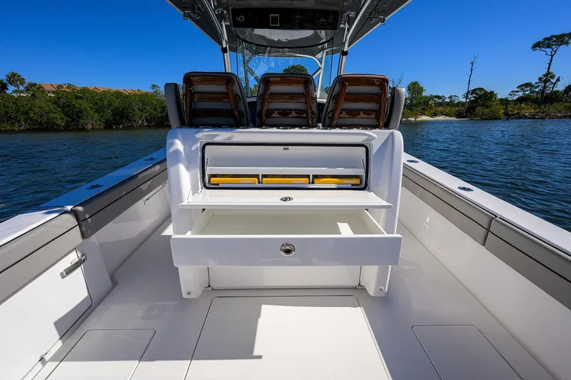Slide: The Image of 2024 Valhalla Boatworks V-33 interior with open storage, on calm water. - 31