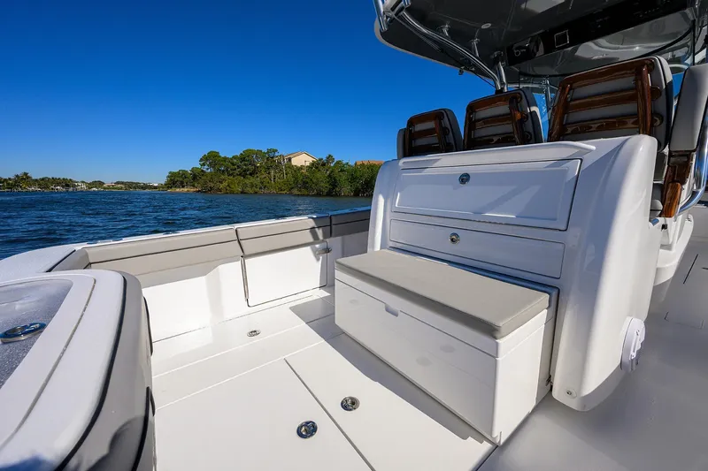 Slide: The Image of 2024 Valhalla Boatworks V-33 interior with seating and storage, cruising on a sunny day. - 36