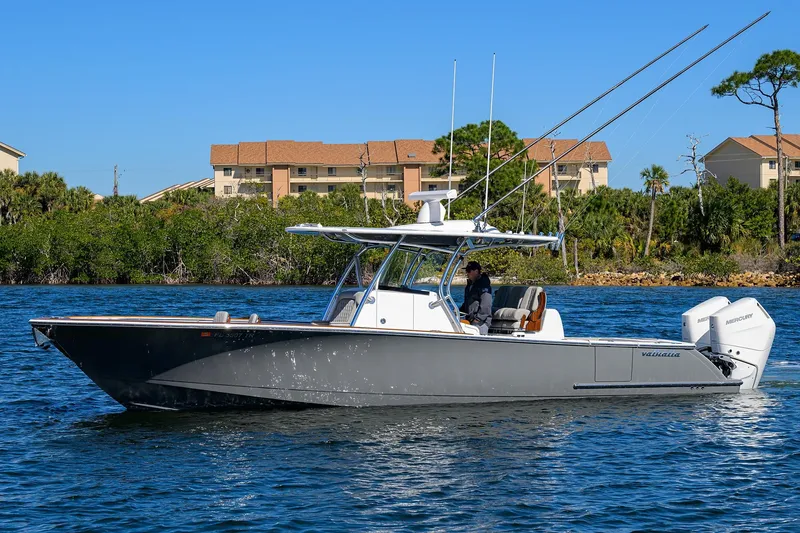 Slide: The Image of 2024 Valhalla Boatworks V-33 on water, sleek design, dual Mercury engines. - 4