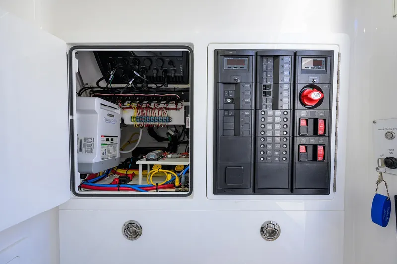 Slide: The Image of 2024 Valhalla Boatworks V-33 electrical panel with wiring and control switches. - 44