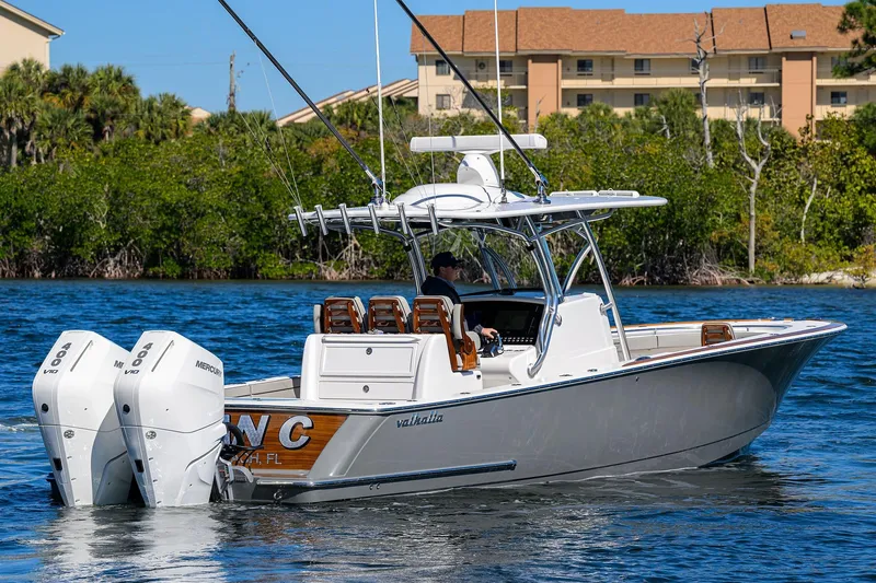 Slide: The Image of 2024 Valhalla Boatworks V-33 cruising on water with twin Mercury engines. - 8