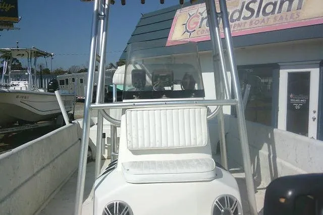 Slide: The Image of 2005 Sundance B22CX boat at dealership, featuring center console and seating. - 14