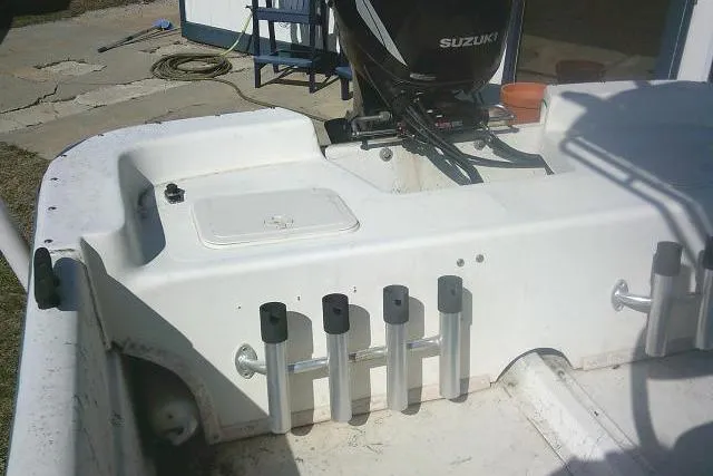 Slide: The Image of Sundance B22CX 2005 boat with Suzuki motor and rod holders on deck. - 19