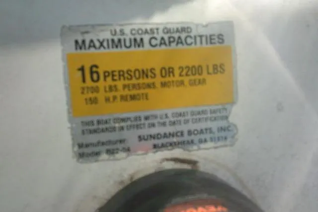 Slide: The Image of U.S. Coast Guard capacity label on 2005 Sundance B22CX boat, 16 persons or 2200 lbs limit. - 22