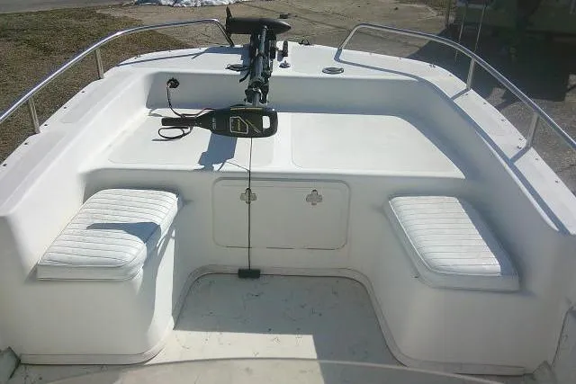 Slide: The Image of 2005 Sundance B22CX boat interior with seating and steering controls. - 24