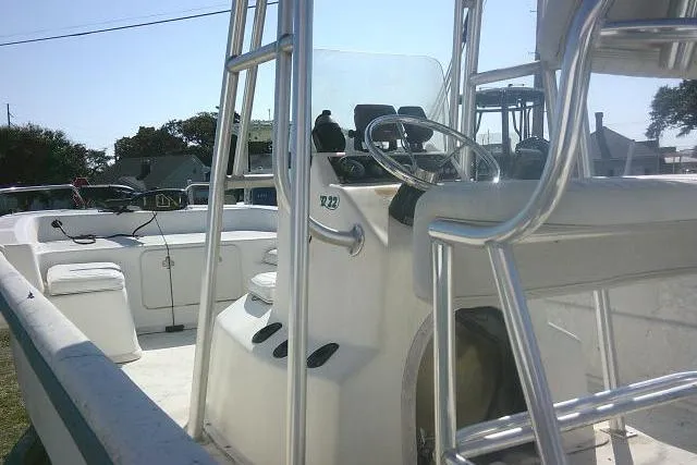 Slide: The Image of 2005 Sundance B22CX boat interior with steering console and seating. - 26