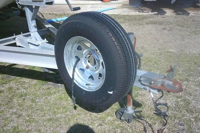 Slide: The Image of Trailer with spare tire attached, Sundance B22CX model, 2005, parked on grass. - 3