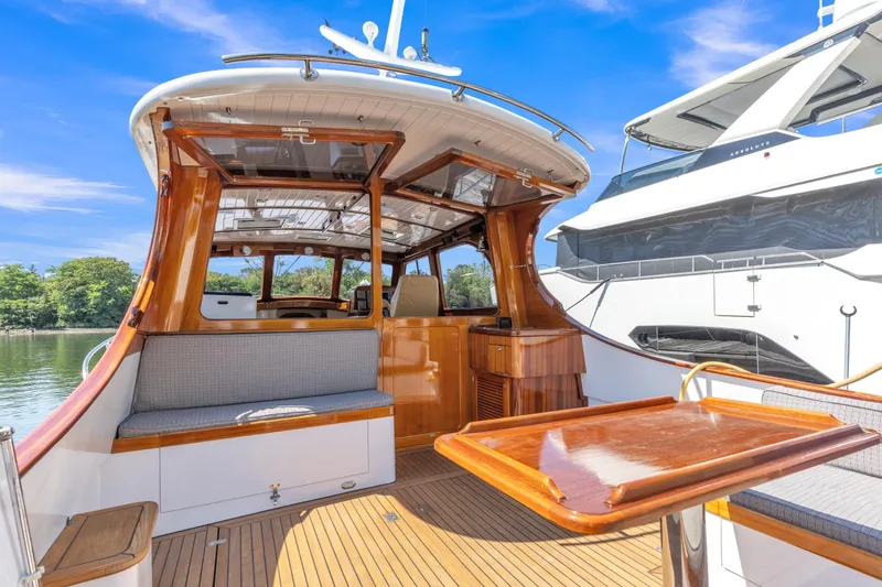 Slide: The Image of 2007 Gorbon Custom Downeast 40 yacht with elegant wood interior and outdoor seating. - 10