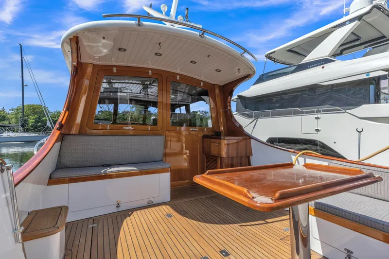Slide: The Image of 2007 Gorbon Custom Downeast 40 yacht interior with wooden deck and seating area. - 11