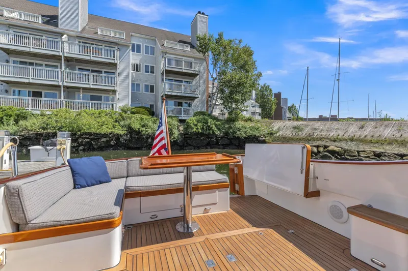 Slide: The Image of Deck of 2007 Gorbon Custom Downeast 40 yacht with seating, docked near waterfront buildings. - 16