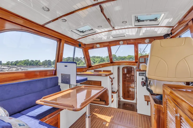 Slide: The Image of Luxurious interior of 2007 Gorbon Custom Downeast 40 yacht with wood finish and blue seating. - 18