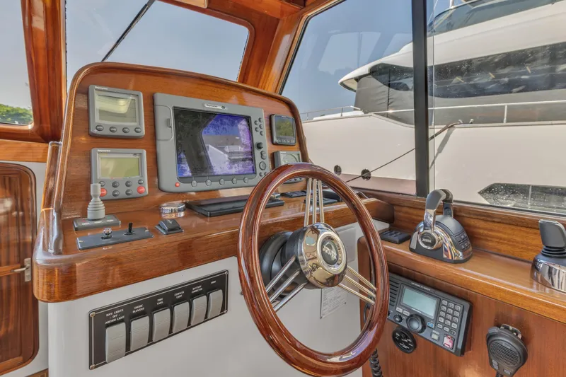 Slide: The Image of Helm of 2007 Gorbon Custom Downeast 40 with navigation equipment and wooden steering wheel. - 22