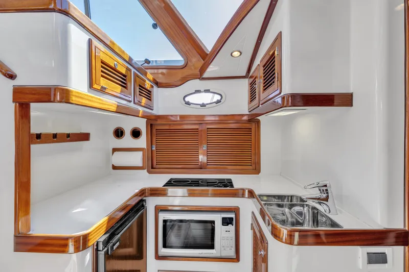 Slide: The Image of Luxurious 2007 Gorbon Custom Downeast 40 yacht kitchen with wood accents and modern appliances. - 25