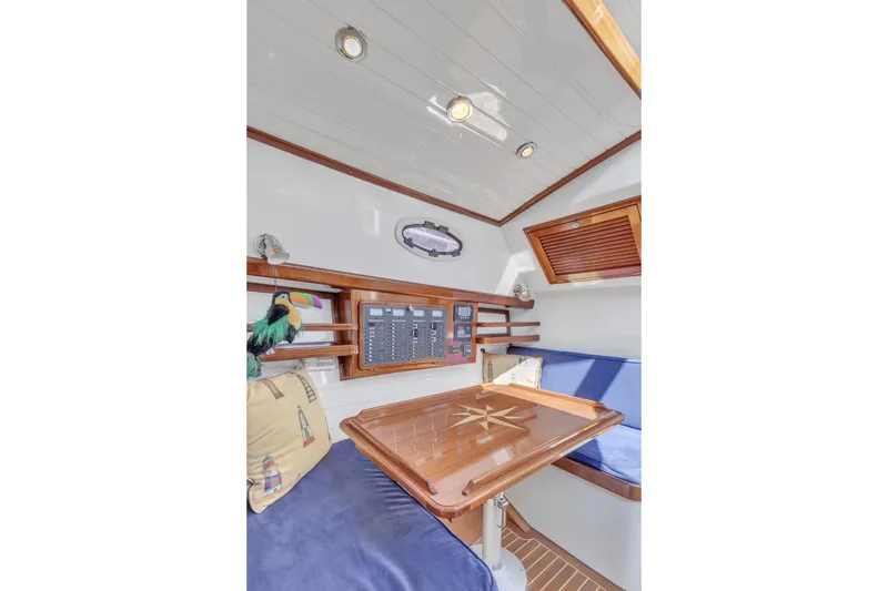 Slide: The Image of Interior of 2007 Gorbon Custom Downeast 40 yacht with wooden table and blue seating. - 37