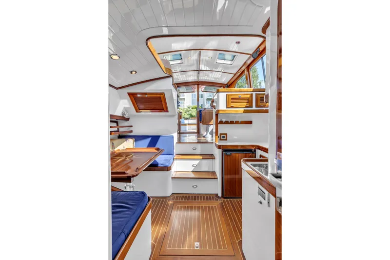 Slide: The Image of Interior of 2007 Gorbon Custom Downeast 40 yacht with wood accents and blue seating. - 38