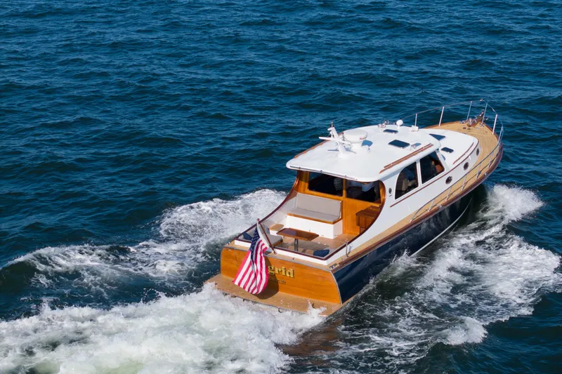 Slide: The Image of 2007 Gorbon Custom Downeast 40 yacht cruising on open water, displaying American flag. - 9