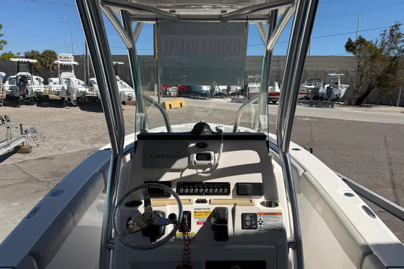 Slide: The Image of 2021 Sea Fox 248 Commander boat dashboard with steering wheel and Garmin navigation system. - 6