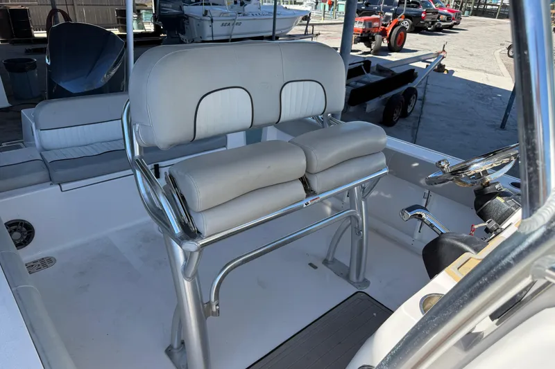 Slide: The Image of 2021 Sea Fox 248 Commander boat interior with cushioned seating and steering console. - 9