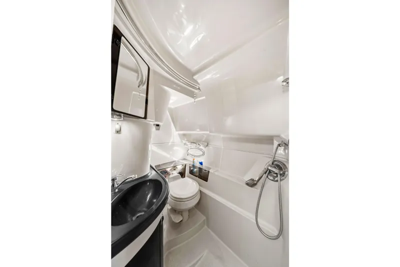 Slide: The Image of 2005 Doral 360se boat bathroom with sink, toilet, and showerhead. - 11
