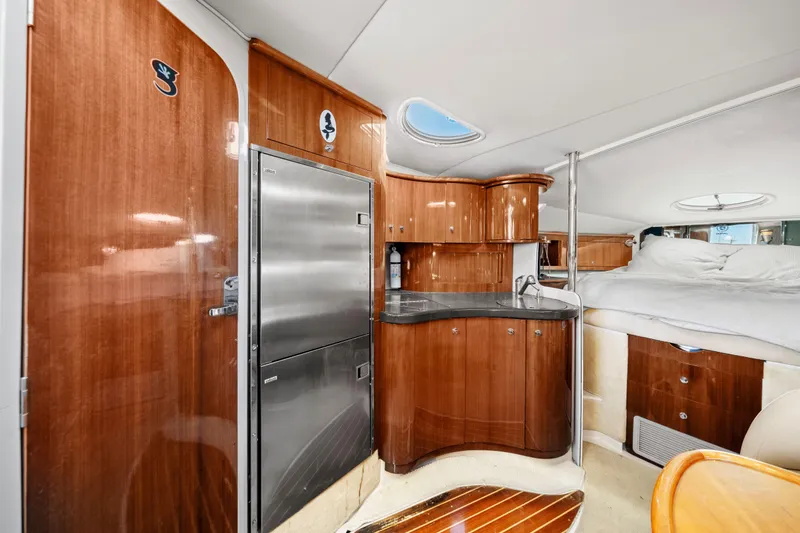 Slide: The Image of Luxurious interior of a 2005 Doral 360se yacht with wood cabinetry and cozy sleeping area. - 12