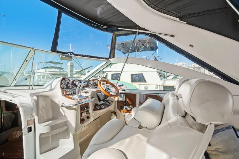 Slide: The Image of Interior view of a 2005 Doral 360se yacht cockpit with luxurious seating and controls. - 19