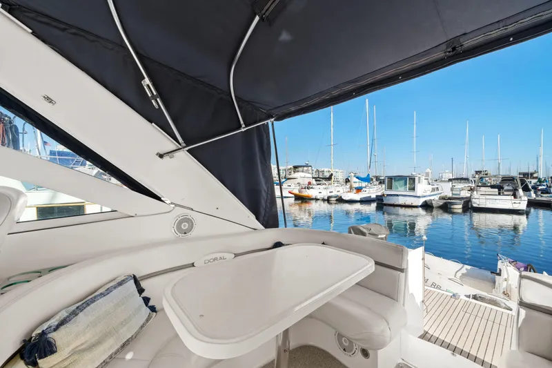Slide: The Image of 2005 Doral 360se yacht interior with marina view, featuring seating and table. - 23