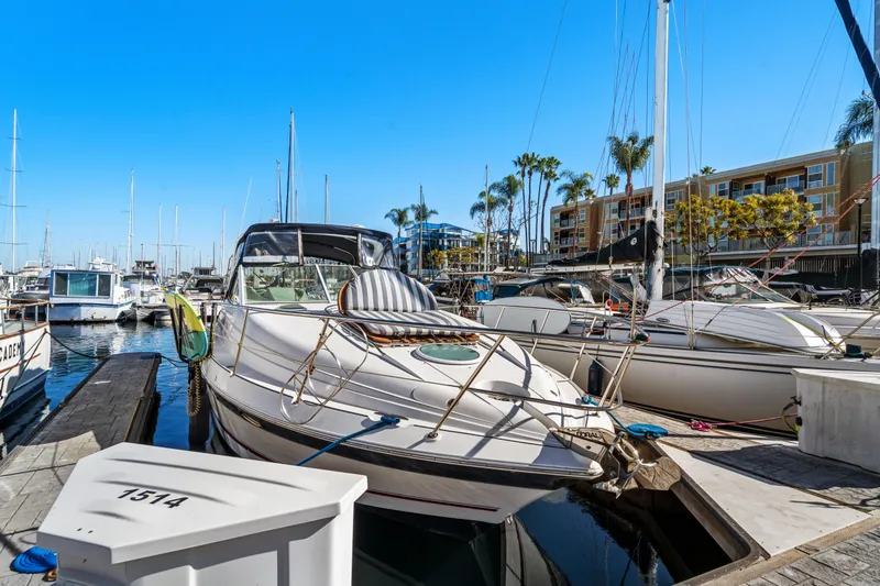 Slide: The Image of 2005 Doral 360se boat docked in a marina under clear blue skies. - 5