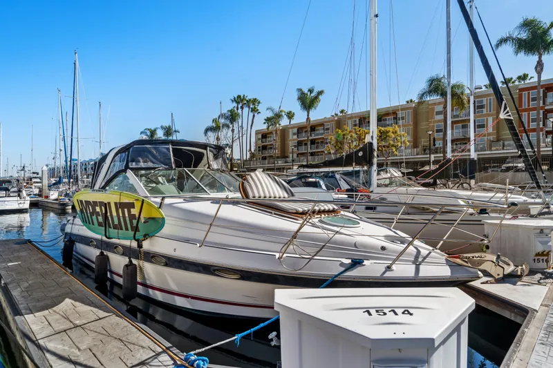 Slide: The Image of 2005 Doral 360se yacht docked at marina with surfboard, palm trees, and buildings in background. - 6