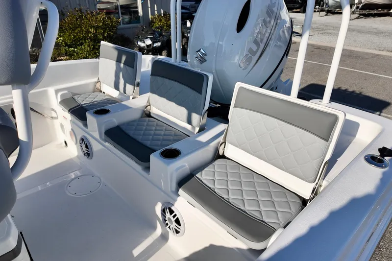 Slide: The Image of 2026 NauticStar 231 Hybrid boat interior with cushioned seating and cup holders. - 10