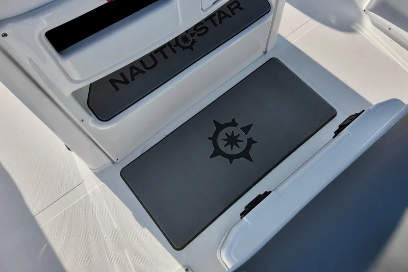 Slide: The Image of 2026 NauticStar 231 Hybrid boat interior with branded flooring and logo. - 11