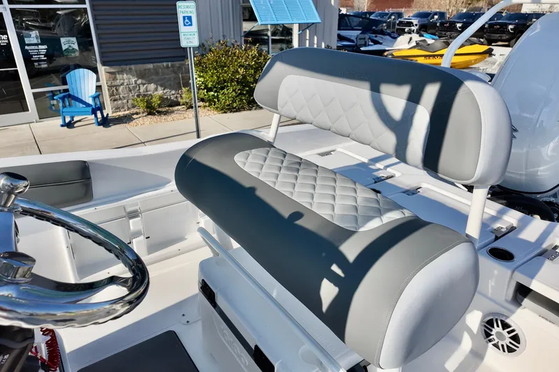 Slide: The Image of 2026 NauticStar 231 Hybrid boat interior with quilted seating and steering wheel. - 12