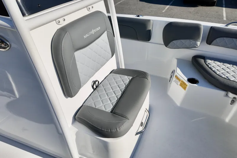 Slide: The Image of 2026 NauticStar 231 Hybrid boat interior with gray and white cushioned seating. - 16
